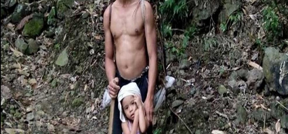five-year-old girl guiding her blind father to work with a stick