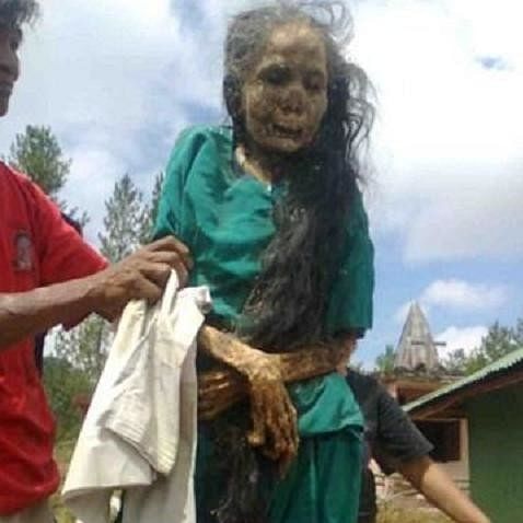 Dead women comes out from grave at Tana Toraja region of South Sulawesi in Indonesia