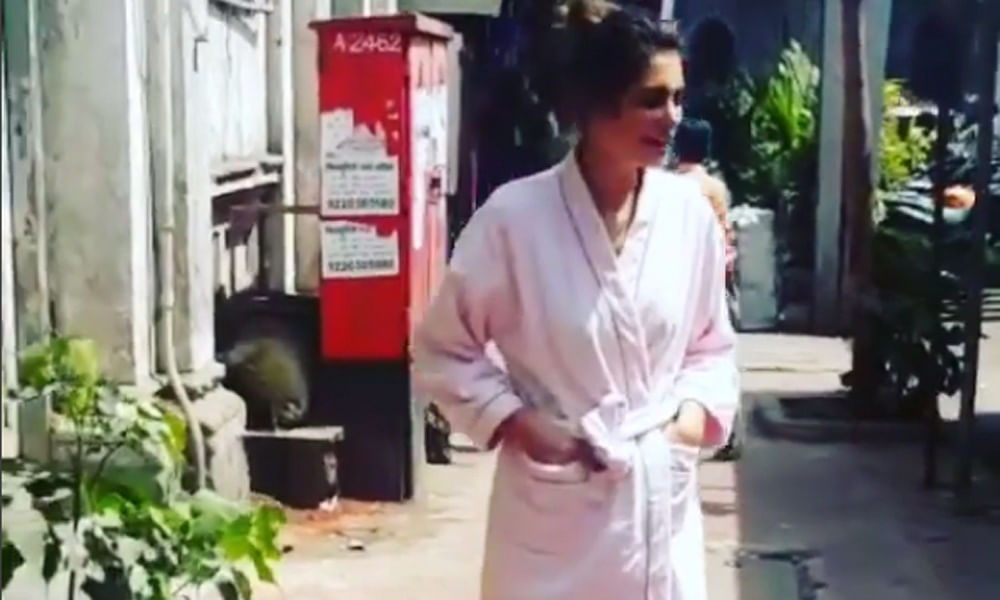 Nargis Fakhri walks in a bathrobe on Mumbai streets