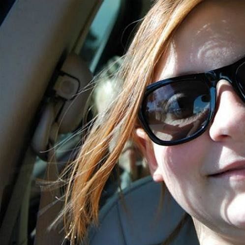 woman taking her selfie in car but there was also someone else