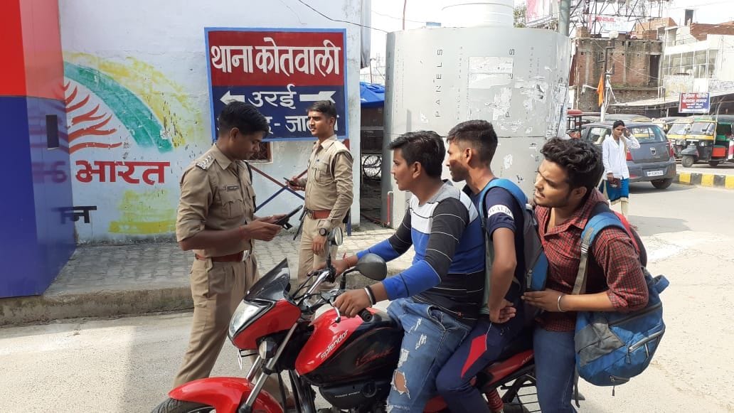 तीन सवारी बिठाने पर वाहन चालक का चालान करते पुलिसकर्मी तीन सवारी बिठाने पर वाहन चालक का चालान करते पुलिसकर्मी