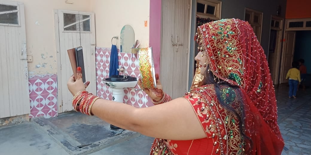 थानाभवन में हसनपुर लुहारी गांव में व्रत खोलते समय पति अनुज का चेहरा देखती पत्नी दीपा थानाभवन में हसनपुर लुहारी गांव में व्रत खोलते समय पति अनुज का चेहरा देखती पत्नी दीपा