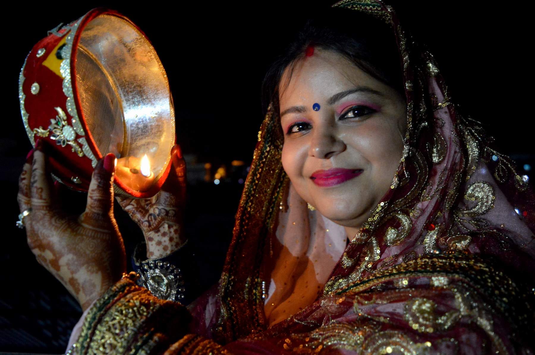 विकासनगर स्थित एक घर में करवाचौथ पूजन के दौरान चांद का दीदार करती महिला।