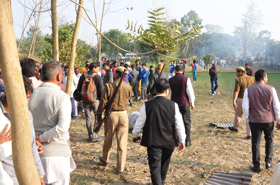 सहारनपुर के पुवारंका में पटाखा फैक्ट्री में विस्फोट के बाद लगी आग जमा  भीड़ को हटाती पुलिस।