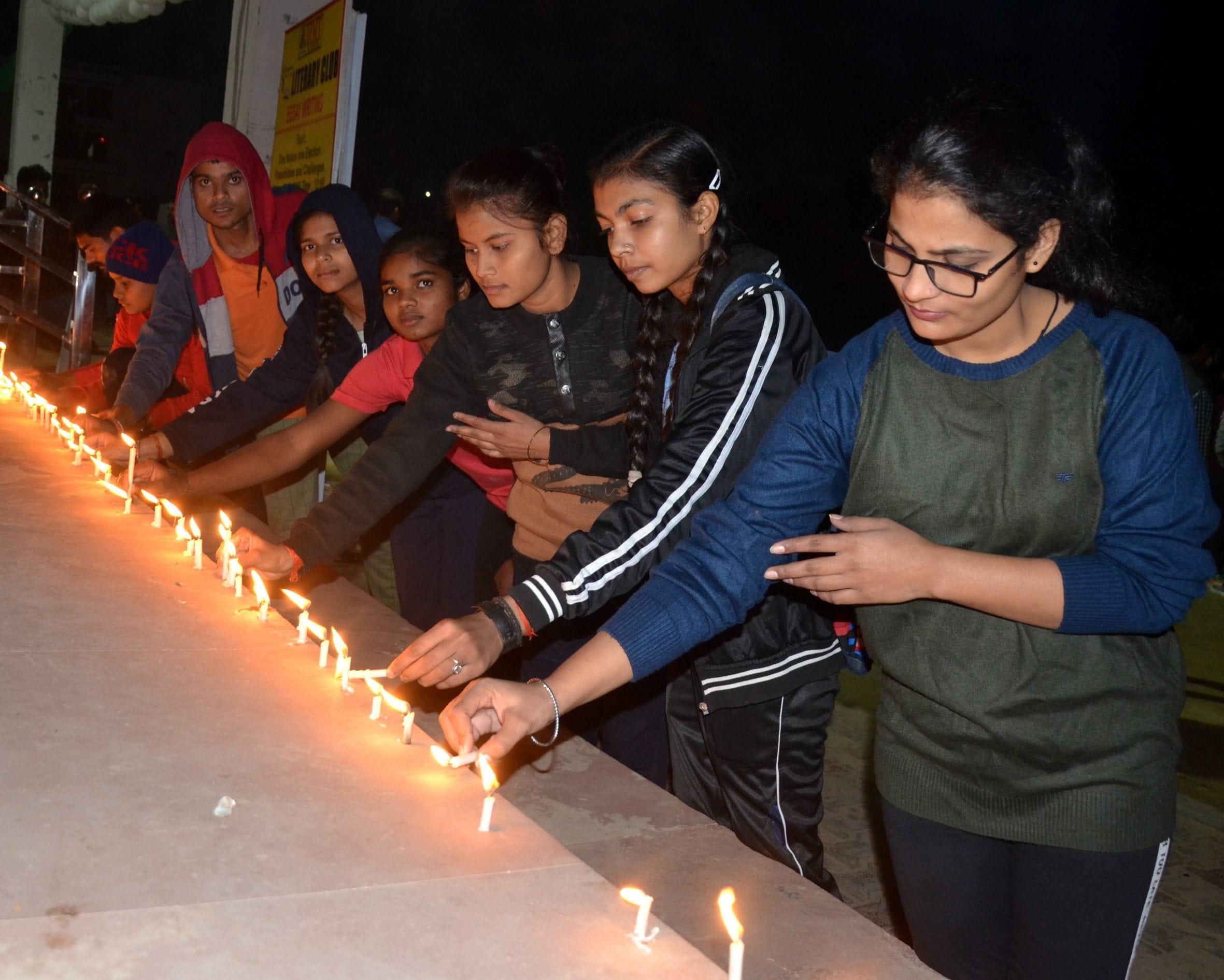कैंडल जलाकर श्रद्धांजलि देते  विद्यार्थी।