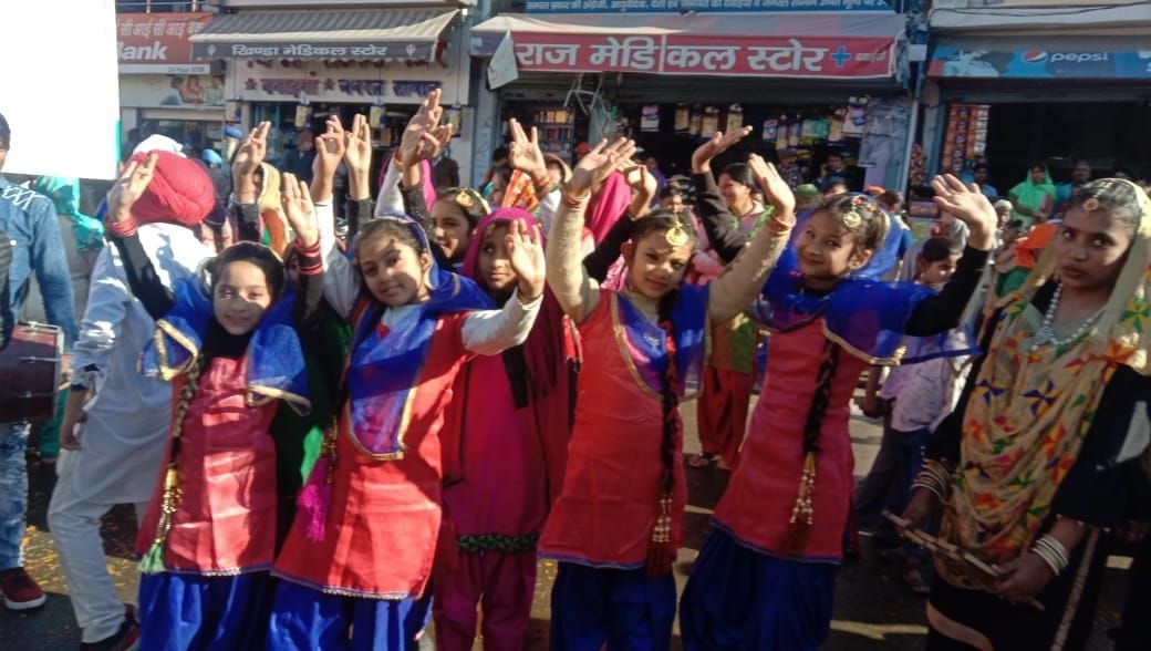 खटीमा में निकले नगर कीर्तन में भांगड़ा प्रस्तुत करते स्कूली बच्चे। खटीमा में निकले नगर कीर्तन में भांगड़ा प्रस्तुत करते स्कूली बच्चे।