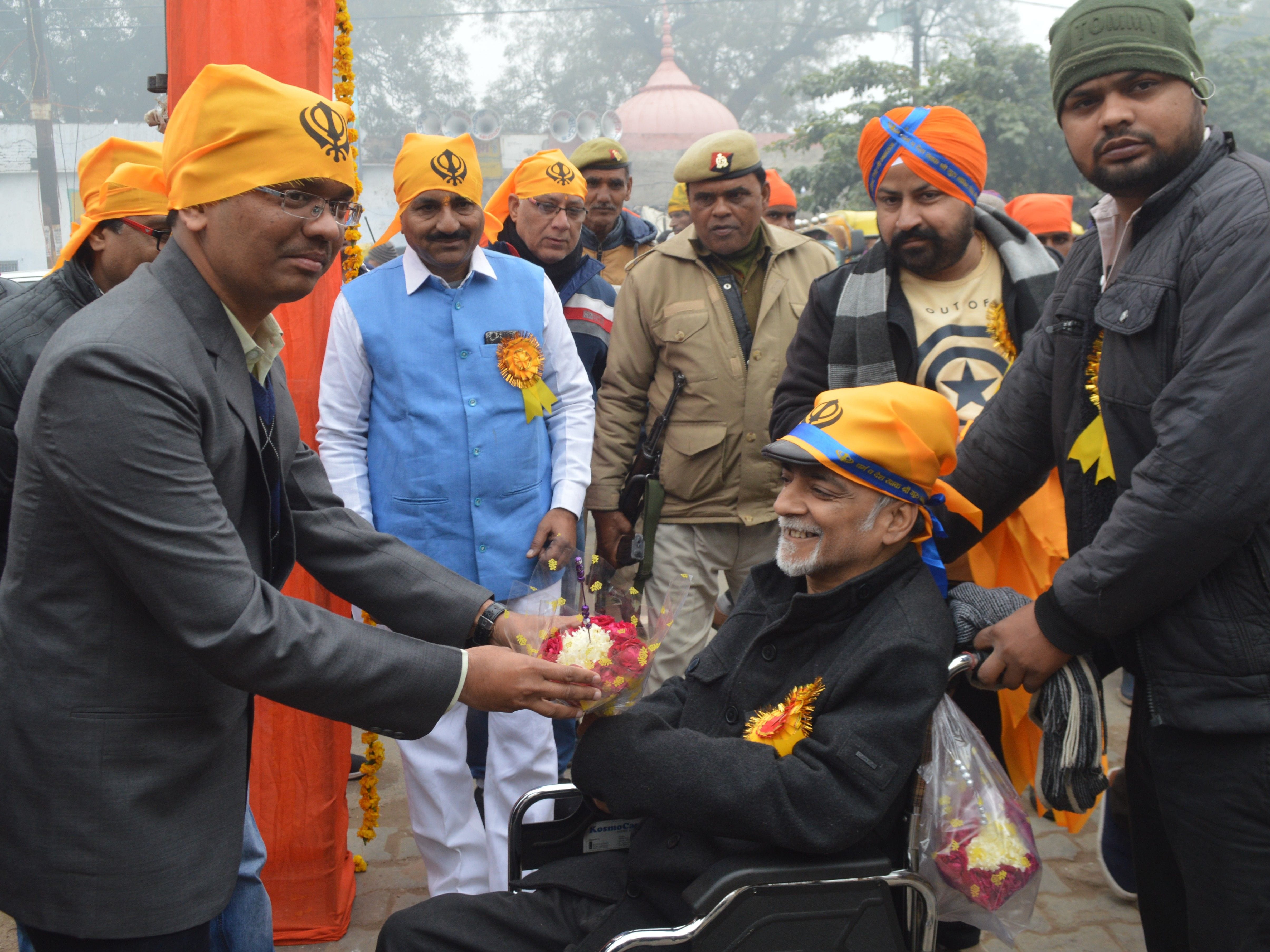 नगर कीर्तन के शुभारंभ पर पहुचे डीएम को गुल्दस्ता देकर सम्मानित करते समाज सेवी नवीन अरोरा।
