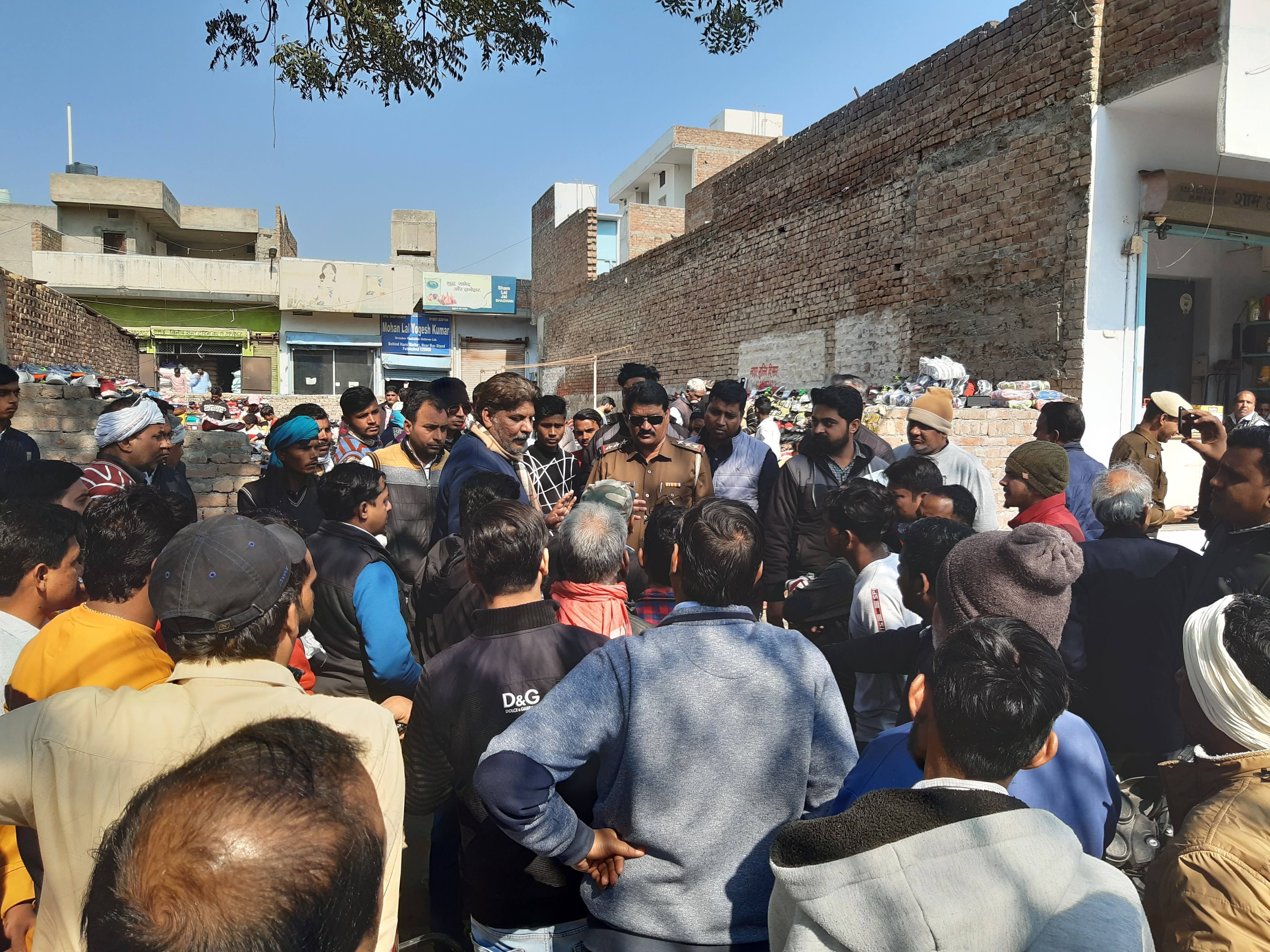 हंस मार्केट में अतिक्रमण हटाने पहुंची टीम के साथ बहस करते दुकानदार