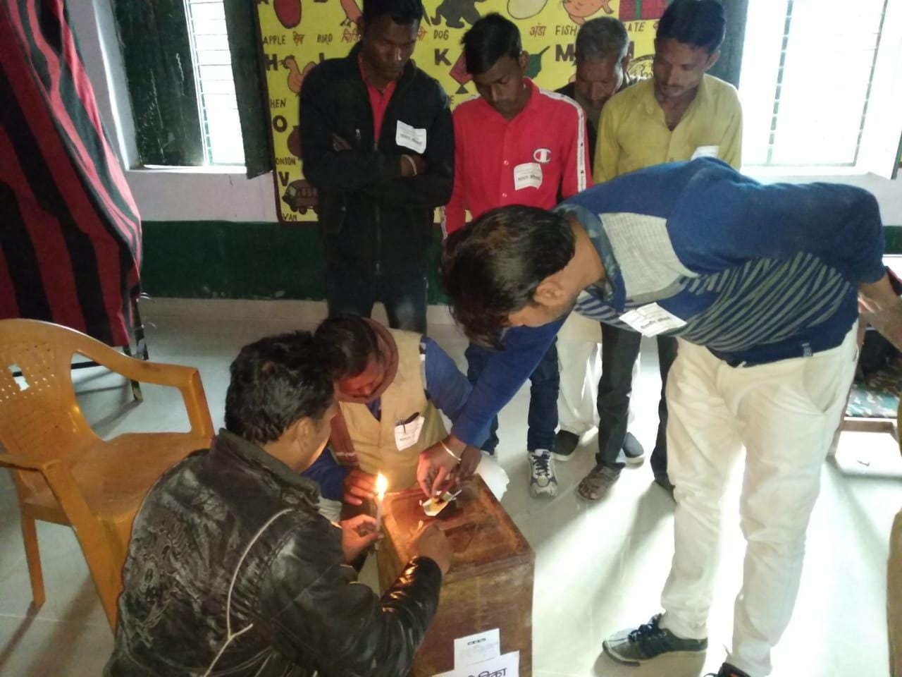 मतदान केंद्र पर पेटी को सील करते कर्मचारी मतदान केंद्र पर पेटी को सील करते कर्मचारी
