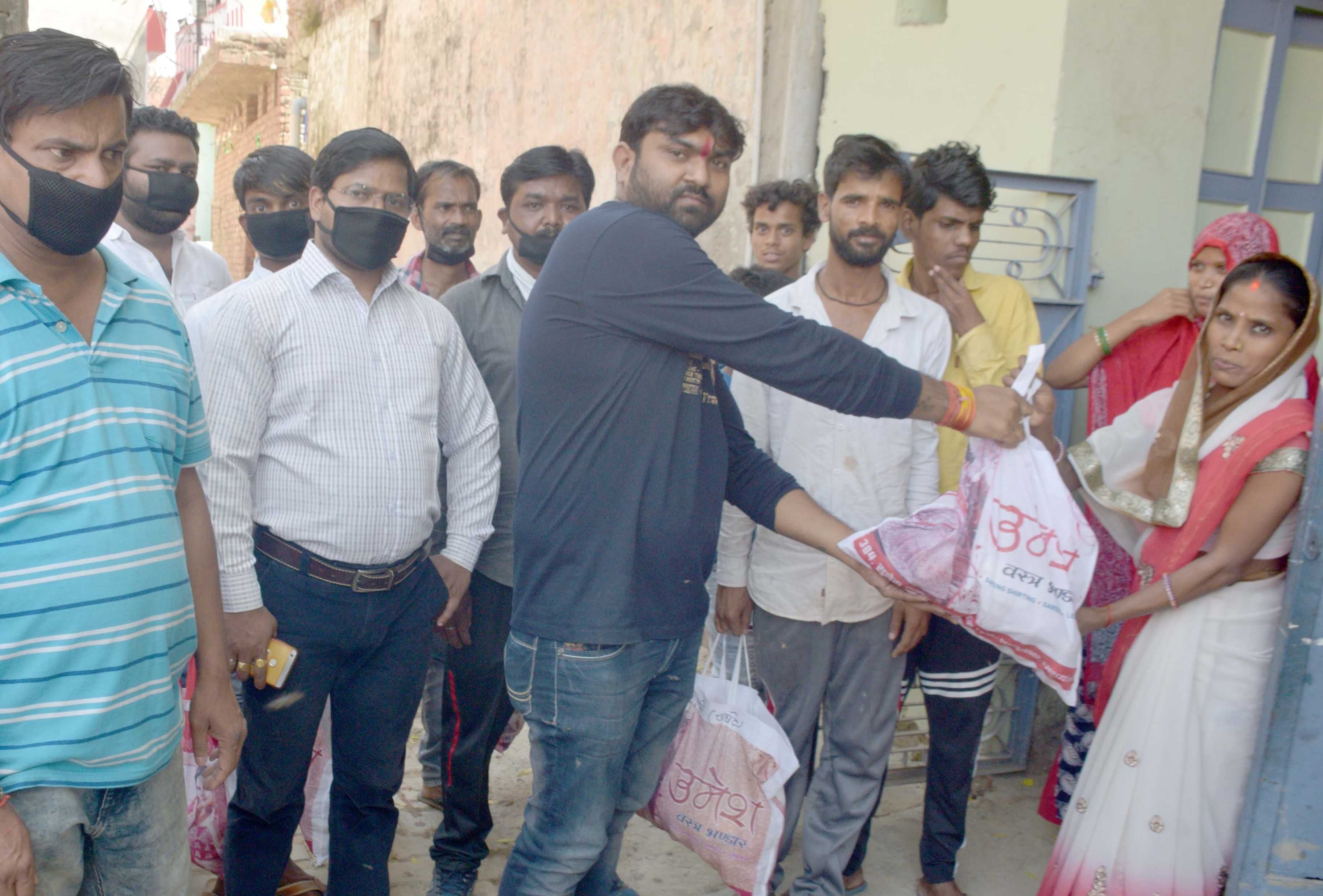 hands extended to help ditributed food packets food grains hands extended to help ditributed food packets food grains