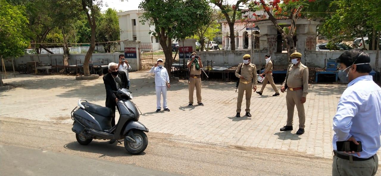 पुलिस क्लब के पास बुजुर्ग को रोककर पूछताछ करते डीएम मन्नान अख्तर