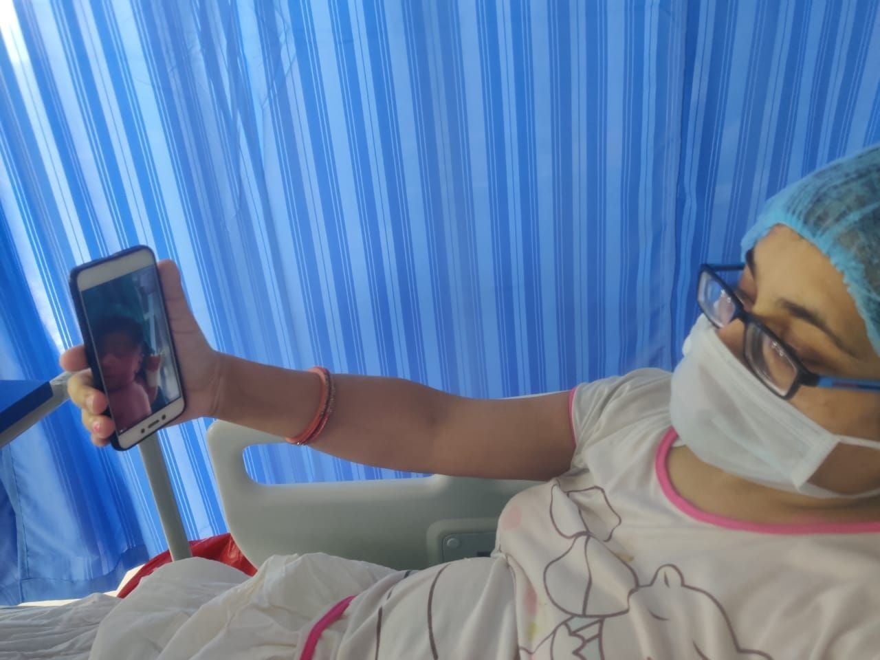 वीडियो काल पर अपनी बेटी की पहली झलक देखती कोरोना संक्रमित मां। वीडियो काल पर अपनी बेटी की पहली झलक देखती कोरोना संक्रमित मां।