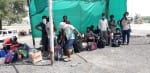 बारा टोल प्लाजा पर बैठे प्रवासी मजदूर।