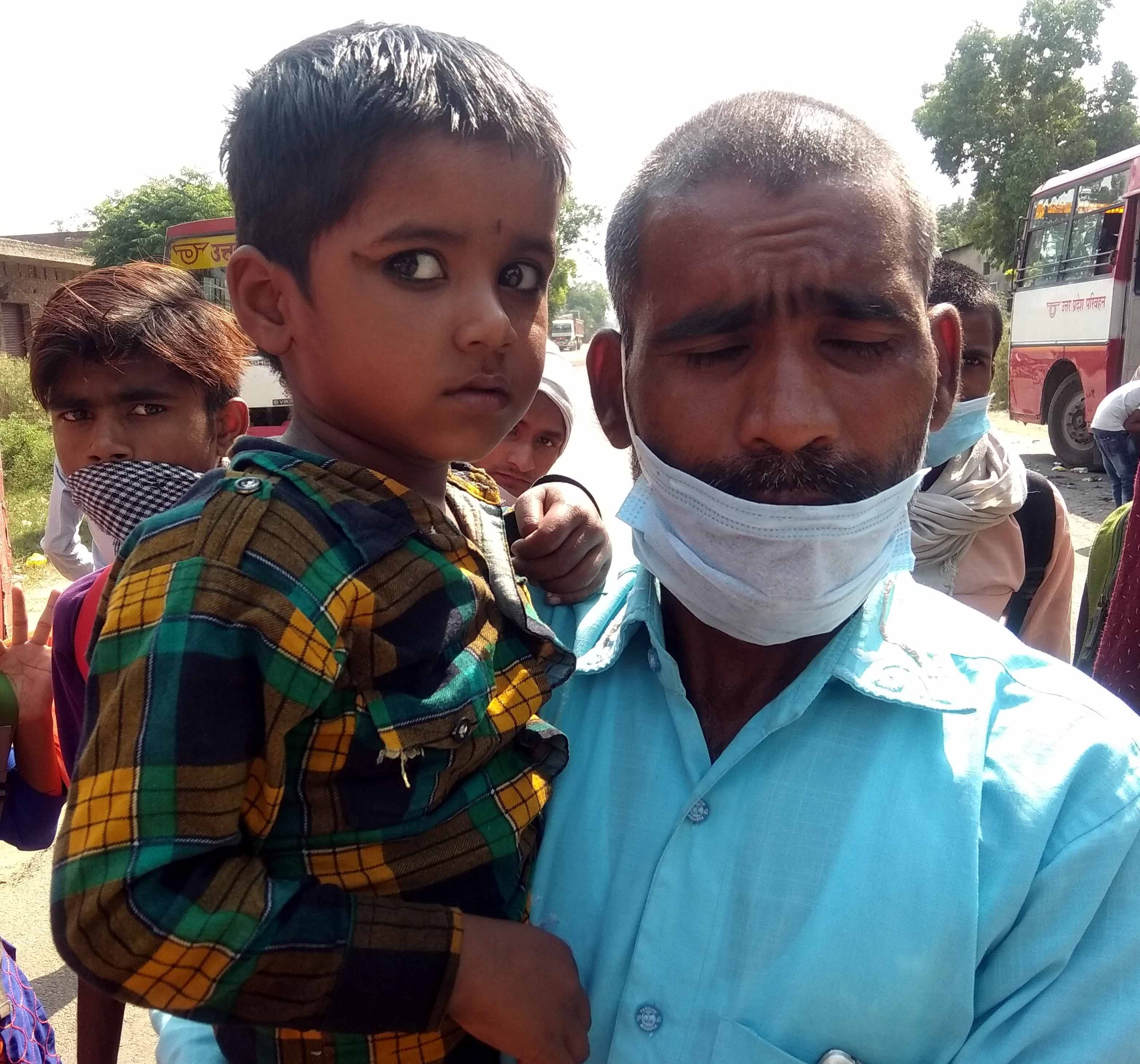 कैराना शेल्टर होम पर कडी धुप में अपने बेटे को गोद में उठाये लखीमपुर खीरी निवासी श्रमिक विरेन्द्र कैराना शेल्टर होम पर कडी धुप में अपने बेटे को गोद में उठाये लखीमपुर खीरी निवासी श्रमिक विरेन्द्र