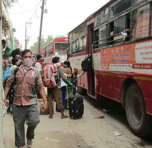 Migrant laborers boarding buses on NH-31 after landing at Ballia railway station.