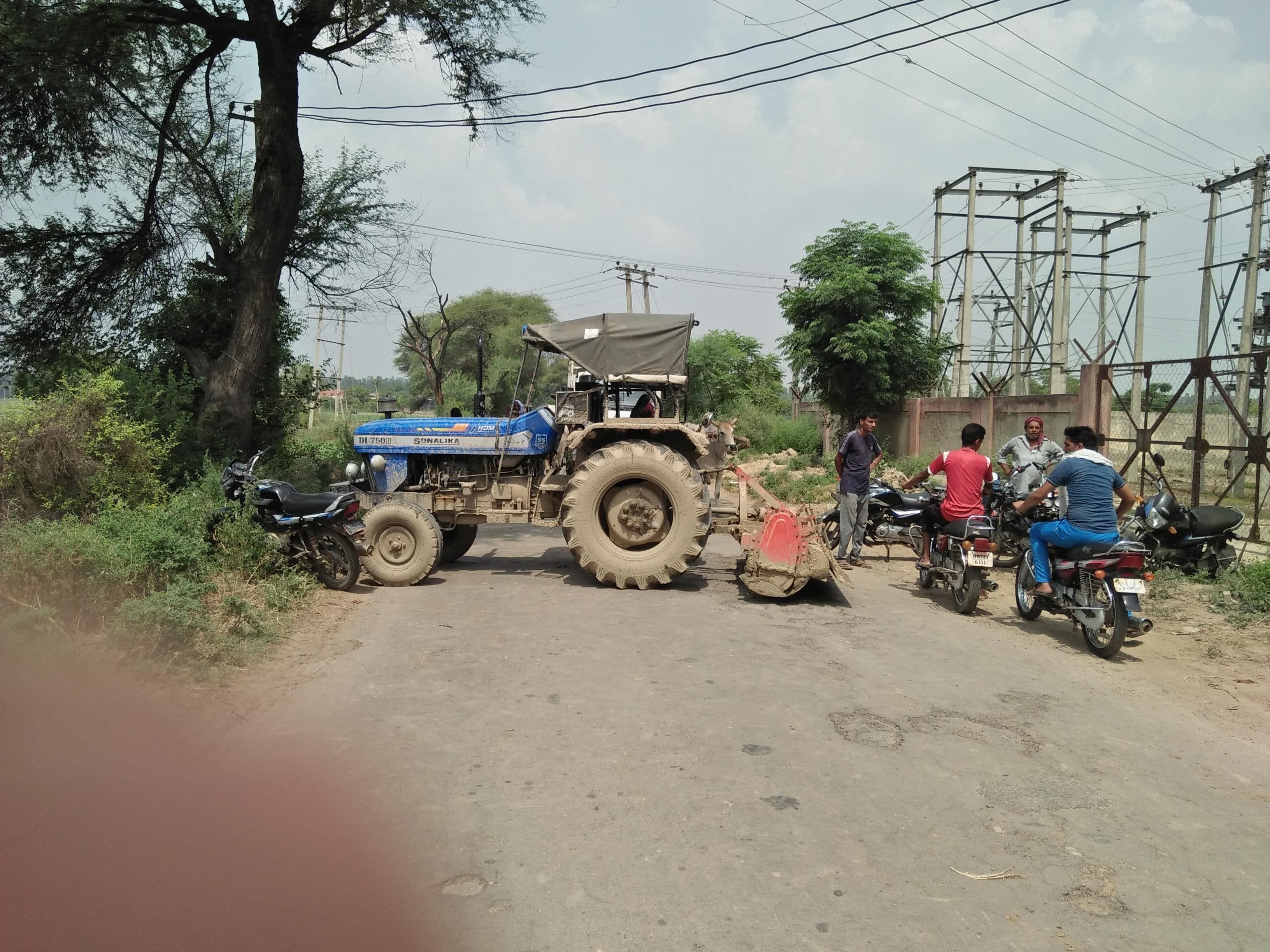  नगूरां-उचाना मार्ग पर बधाना बिजली घर के सामने जाम लगाते लोग।