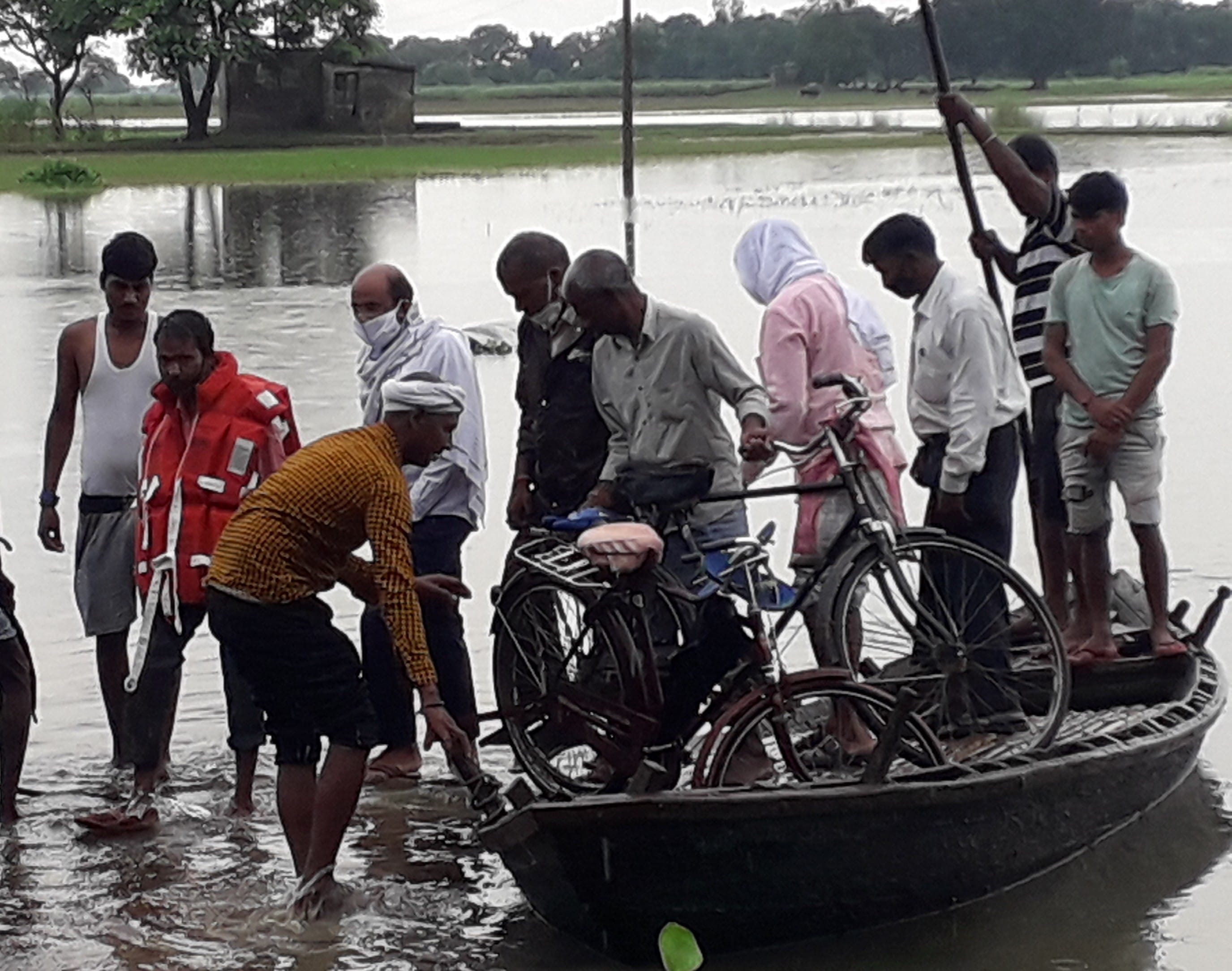 सगड़ी में बाढ़ क्षेत्र से निकल कर आते लोग।