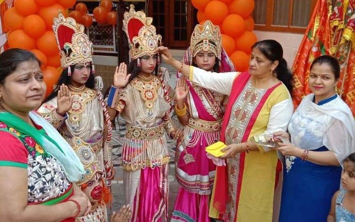 शामली राम सीता लक्ष्मण के रूप में सजे बच्चो को तीलक करती महिला शामली राम सीता लक्ष्मण के रूप में सजे बच्चो को तीलक करती महिला