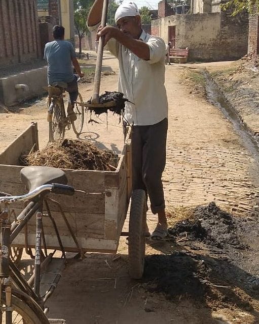 ऊन क्षेत्र के गांव बल्लामजरा में सड़क की सफाई करता सफाई कर्मचारी