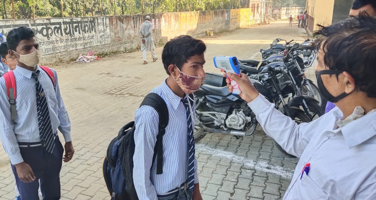 थर्मल स्क्रिनिंग करते अध्यापक थर्मल स्क्रिनिंग करते अध्यापक