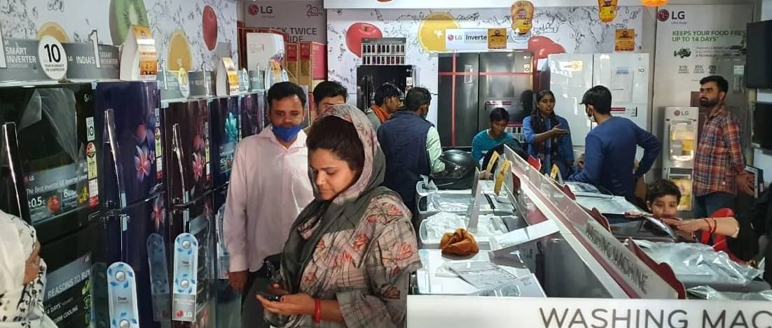 इलेक्ट्रॉनिक की दुकान पर खरीदारी करते लोग। इलेक्ट्रॉनिक की दुकान पर खरीदारी करते लोग।