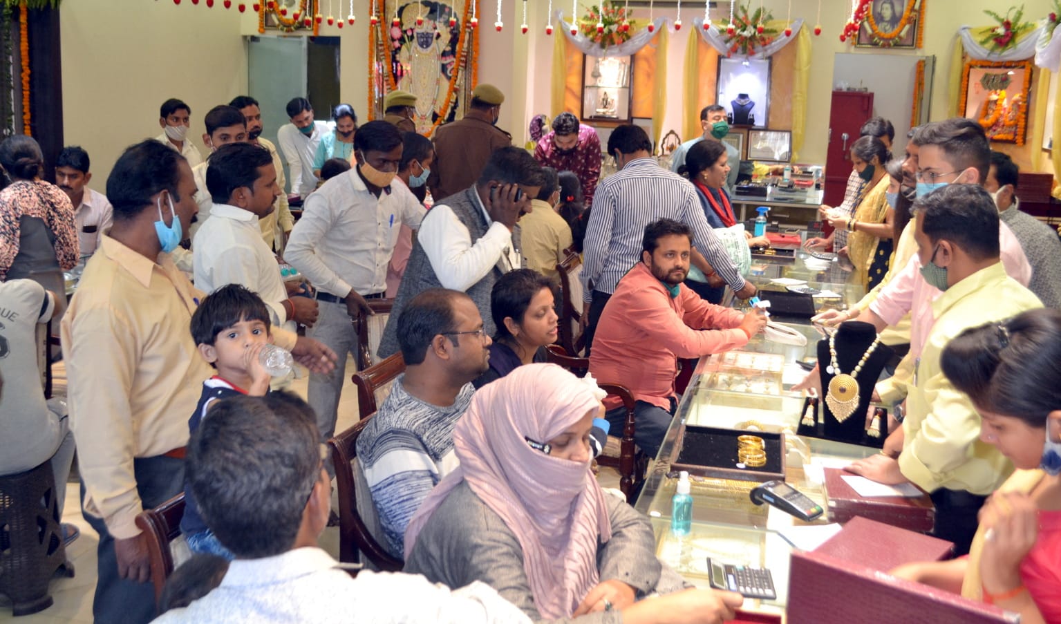 सराफा दुकान पर खरीदारी करते लोग सराफा दुकान पर खरीदारी करते लोग