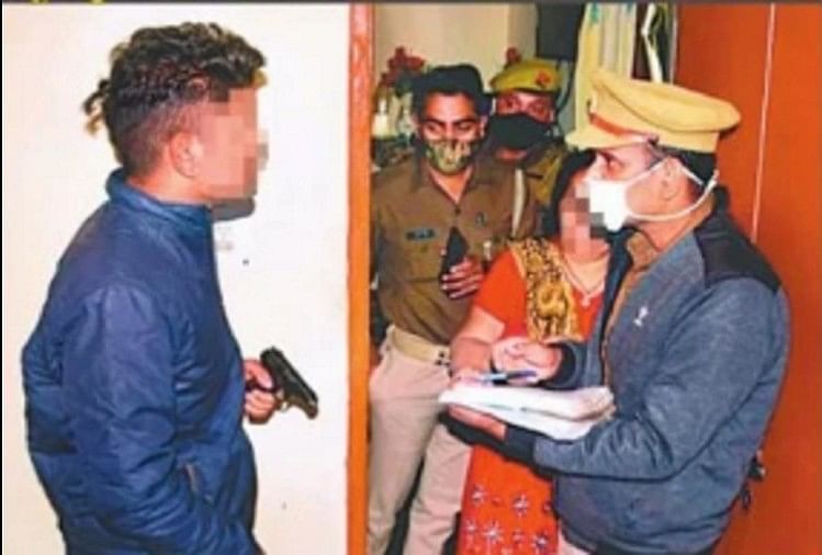 Accused youth handing pistol to police