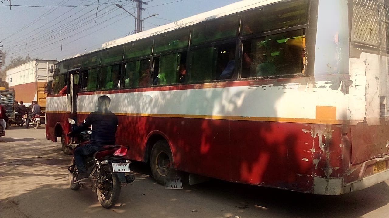बस स्टेंड से गुजरती रोडवेज कलर की प्राइवेट बस ।संवाद बस स्टेंड से गुजरती रोडवेज कलर की प्राइवेट बस ।संवाद