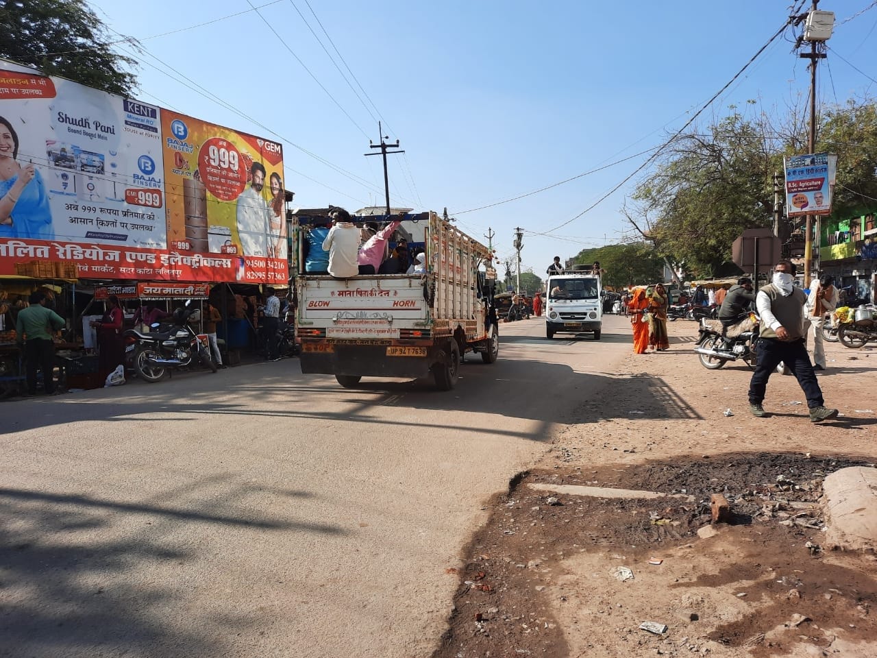 पिकप में सवार होकर जाते लोग पिकप में सवार होकर जाते लोग