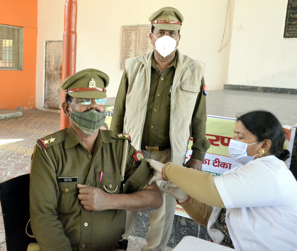 पुलिस लाइन में पुलिसकर्मी को टीकाकरण करते स्वास्थकर्मी।
