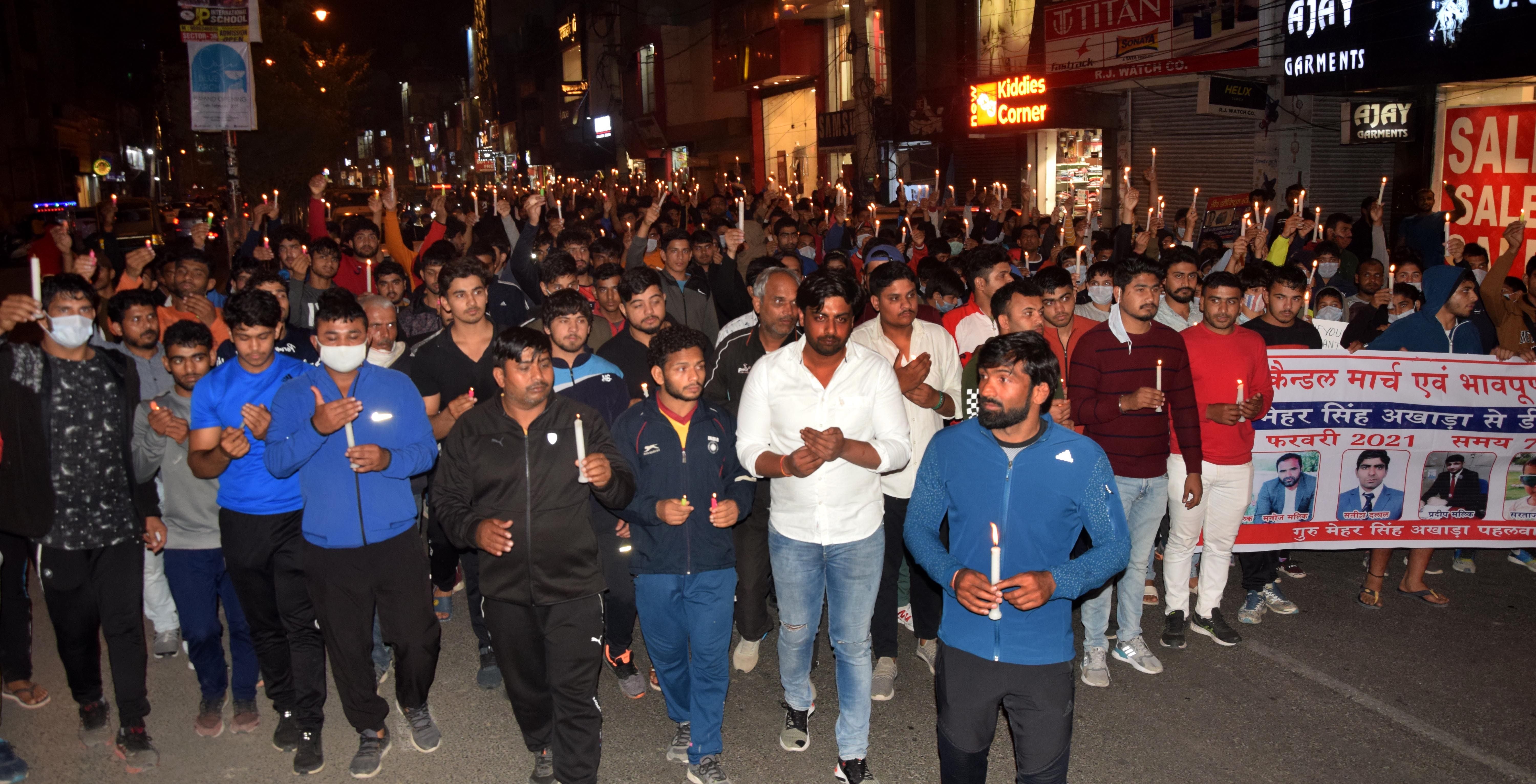 कैंडल मार्च में शामिल जूनियर पहलवान और कोच के साथ अंतरराष्ट्रीय पहलवान योगेश्रवर दत। अमर उजाला