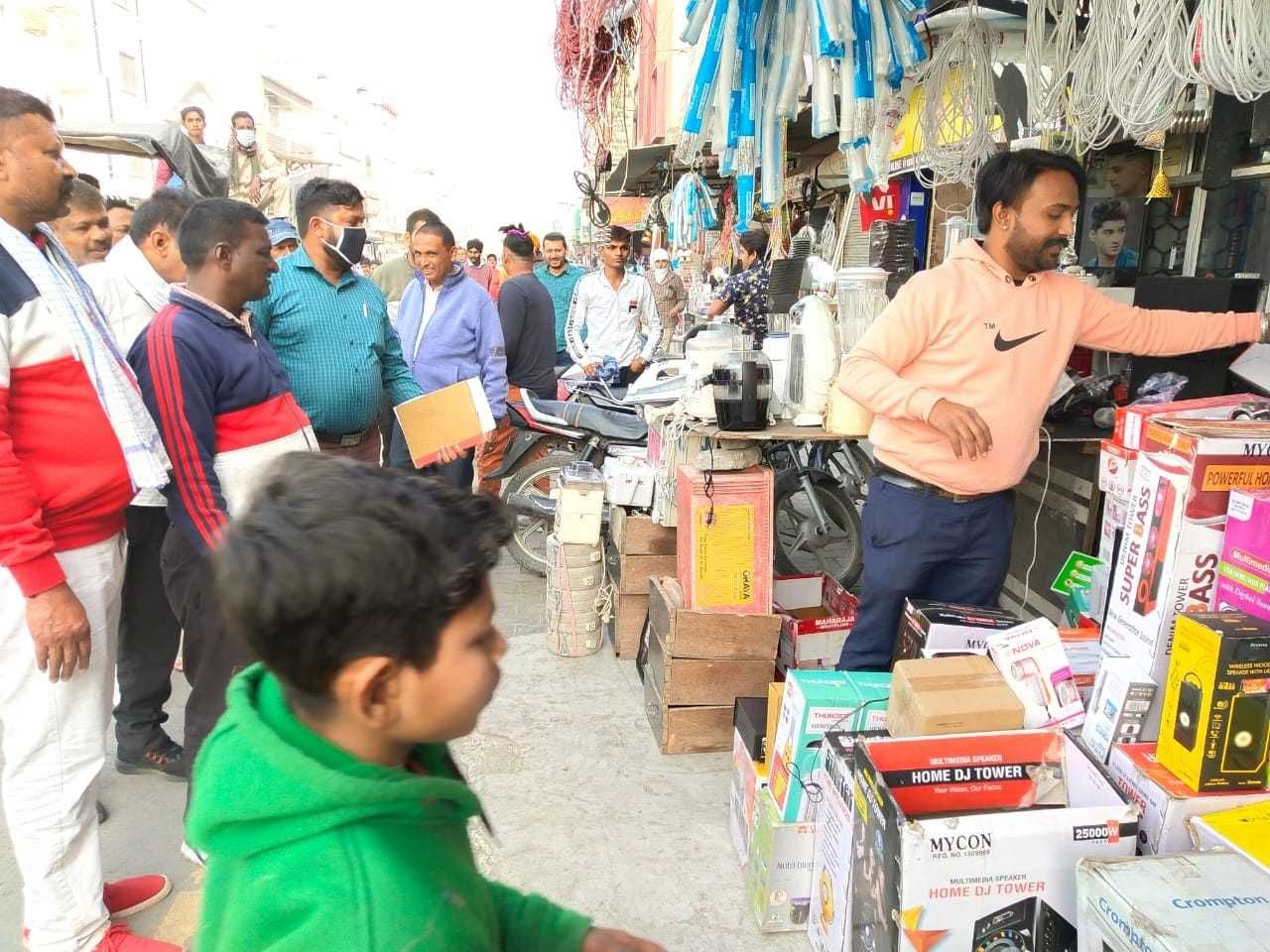 सर्कुलर रोड पर दुकान के बाहर रखे बिजली के सामान को हटवाते नप कर्मी।