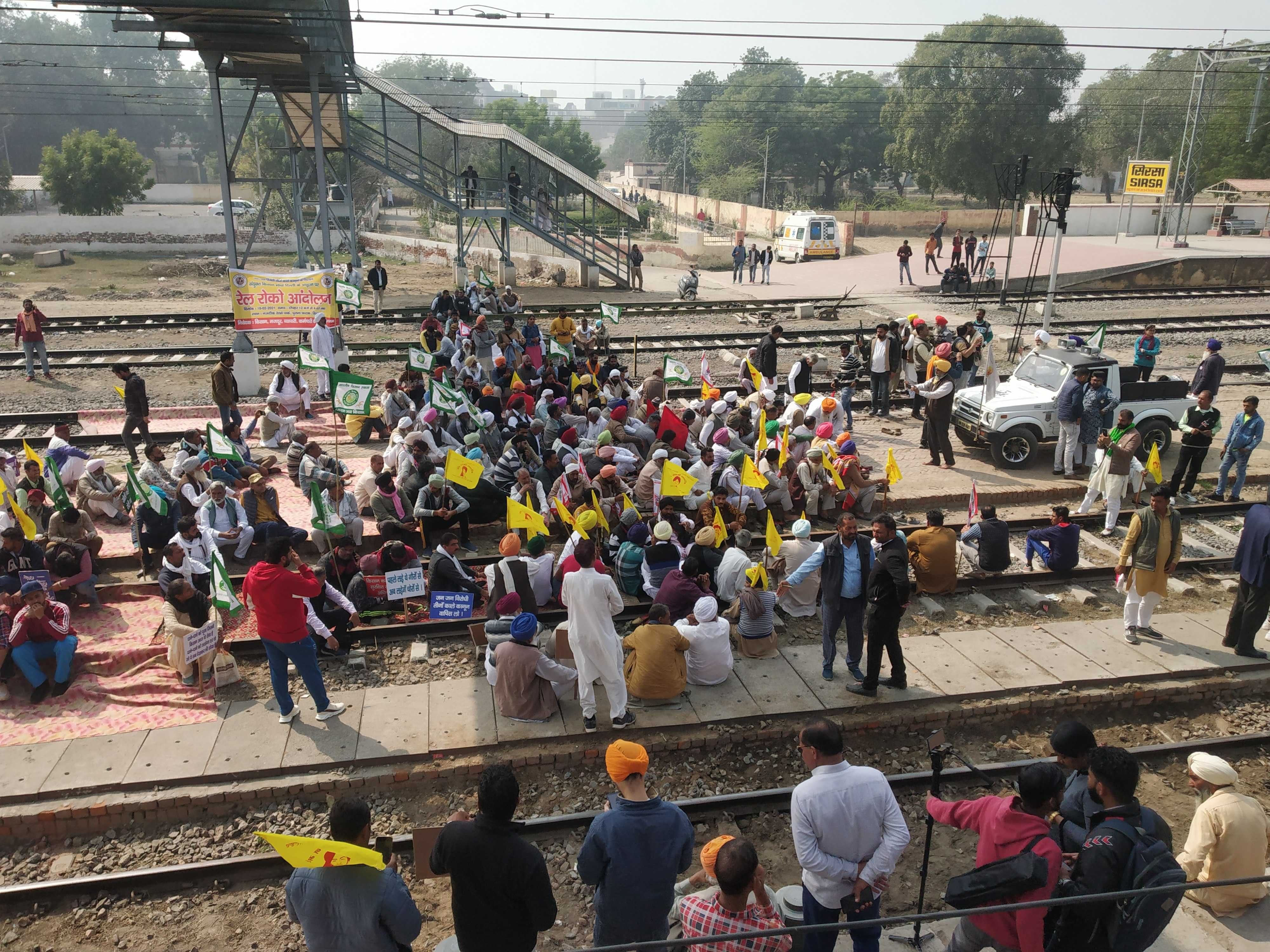 रेलवे स्टेशन पर धरना देकर बैठे किसान।