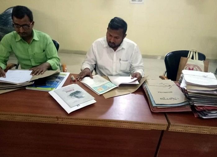 फाइलों की जांच में जुटा नेशनल हाईवे महकमा, नहीं मिला मुआवजा, कार्यदायी संस्था ने काम कराने में पकड़ी तेजी फाइलों का मुआयना करते एनएचएआई के सर्वेयर।