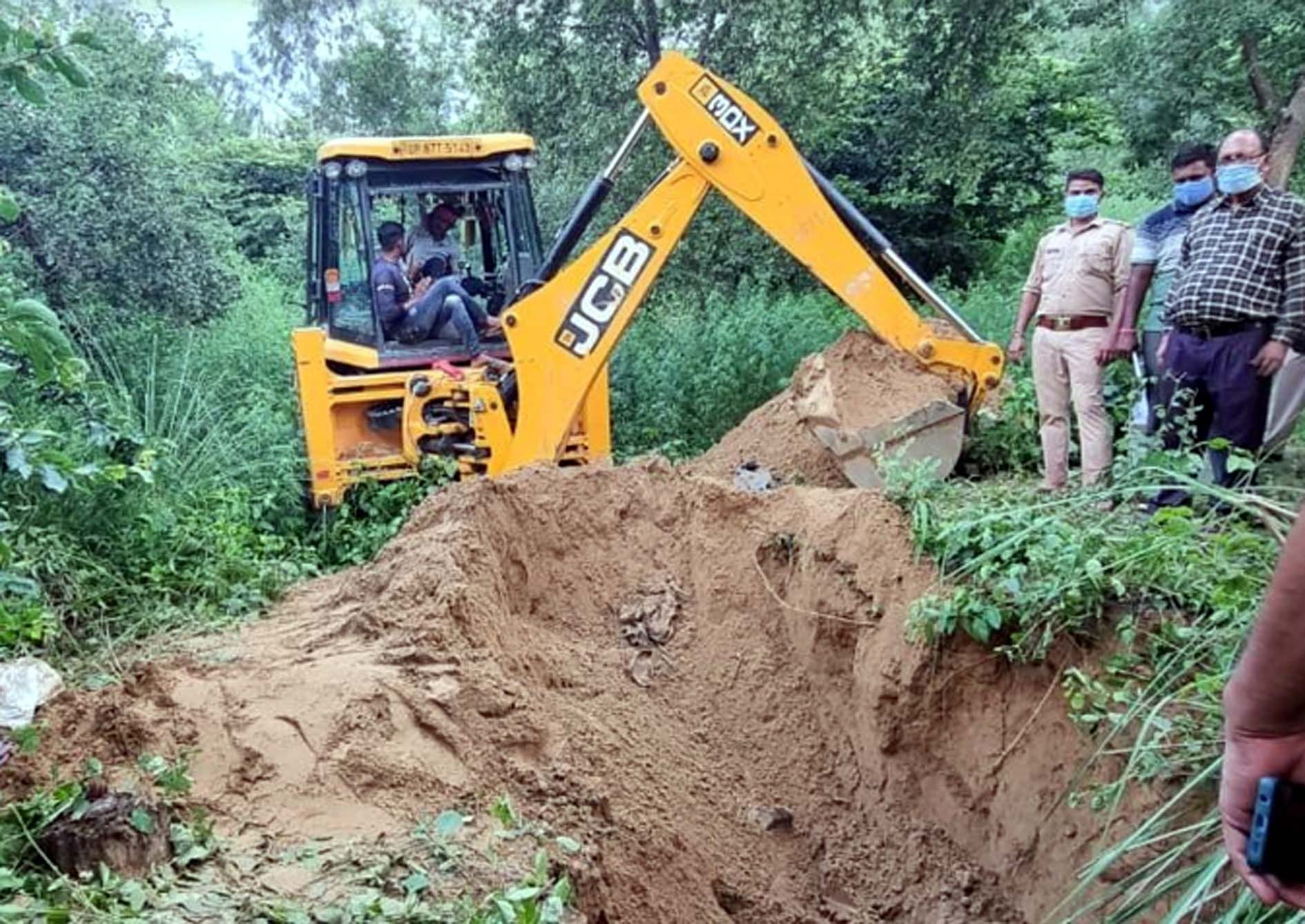 कासगंज पटियाली के जंगल में खोदाई करके युवक का कंकाल बरामद करते पुलिस व प्रशासनिक अधिकारी
