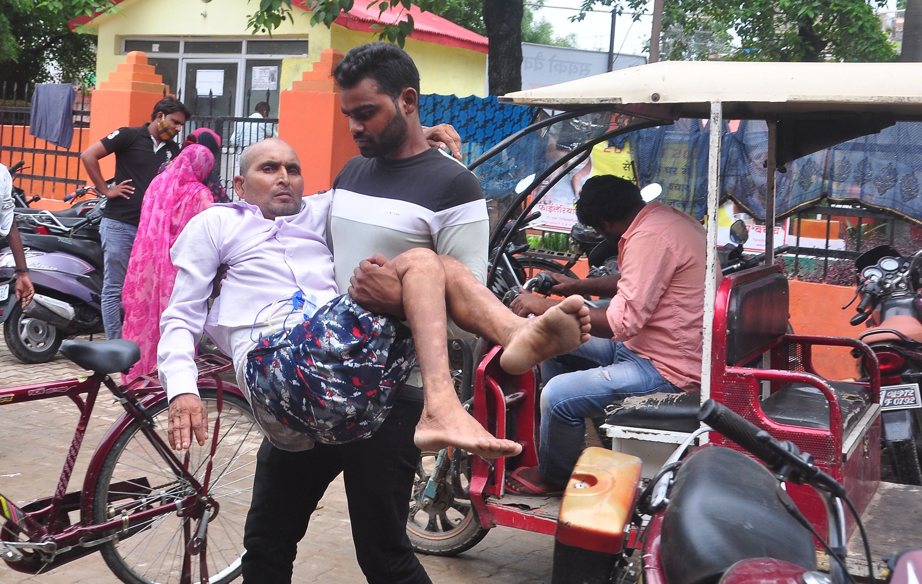 ेडिकल कालेज में ई रिक्सा से उतारकर मरीज को लेकर जाता युवक। संवाद ेडिकल कालेज में ई रिक्सा से उतारकर मरीज को लेकर जाता युवक। संवाद