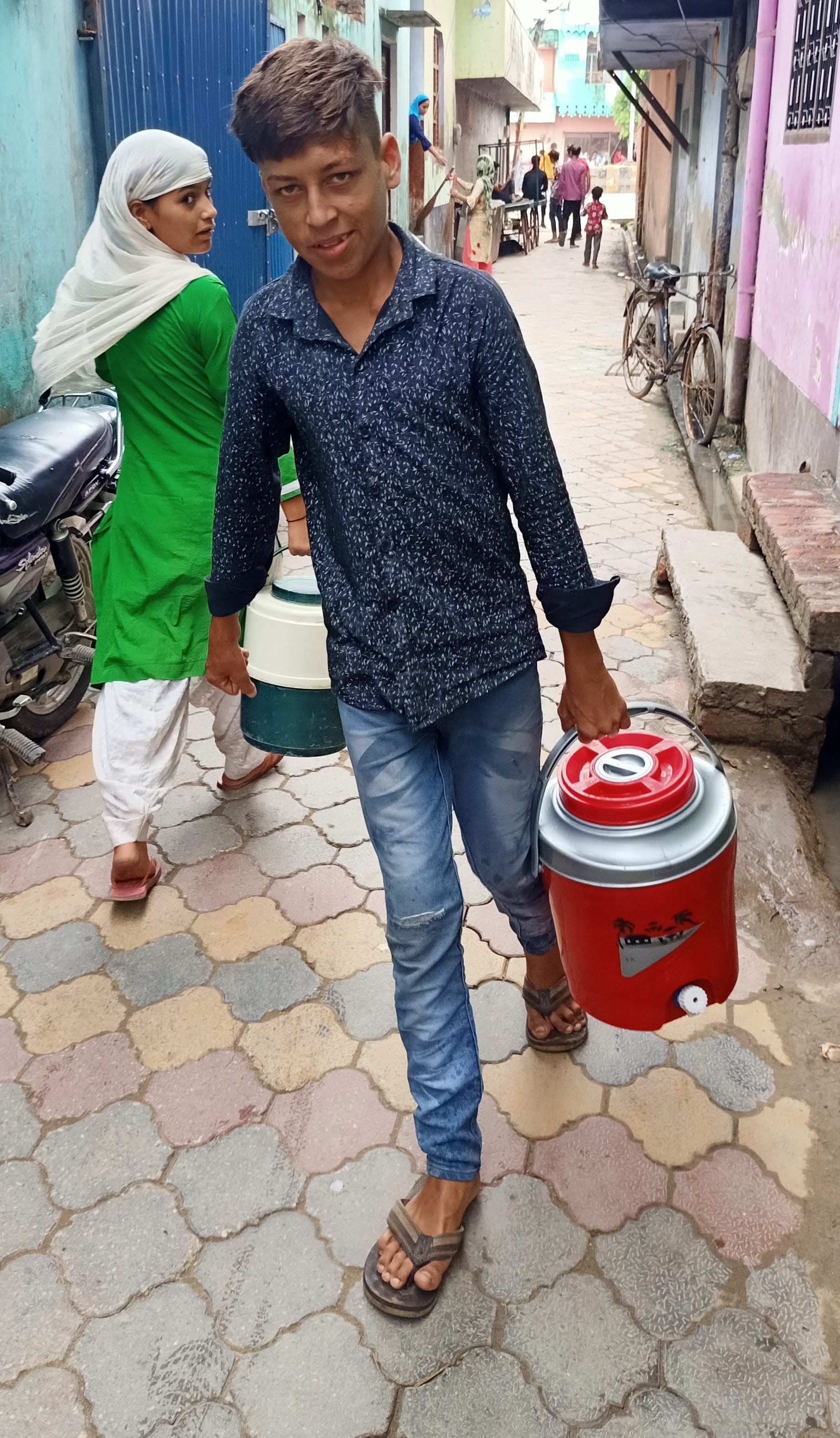 कांधला  के मौहल्ला शेखजादगान में पानी लेकर आता बालक
