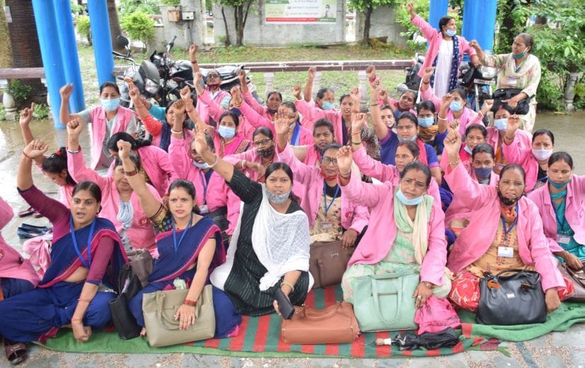 रुद्रपुर जिला अस्पताल परिसर में धरना देतीं आशा कार्यकर्ता।