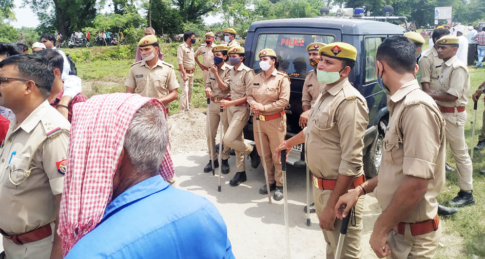 पलिया के त्रिकोलिया बस स्टैंड पर ग्रामीणों को रोकने के लिए तैनात पुलिस बल। संवाद