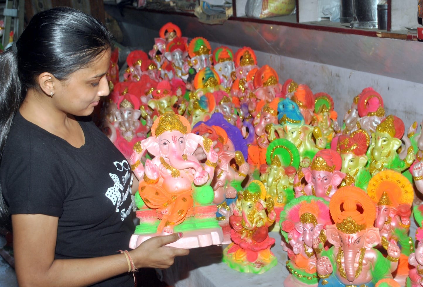 शामली में गणेश जी माहाराज की मूर्ति की खरिदारी करती युवती