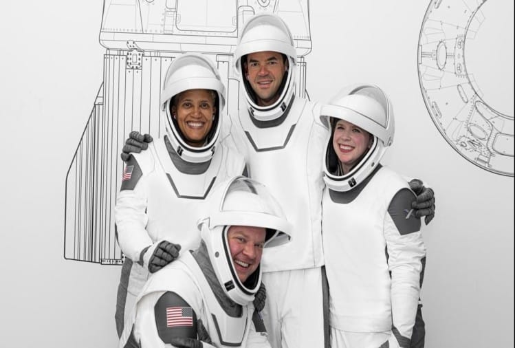 Inspiration4 मिशन में शामिल अंतरिक्षयात्री सियान प्रॉक्टर, जैरेड आइजकमैन, हेली आरसेनाउ (बाएं से दाएं) और क्रिस सेंब्रोस्की (बैठे हुए)।