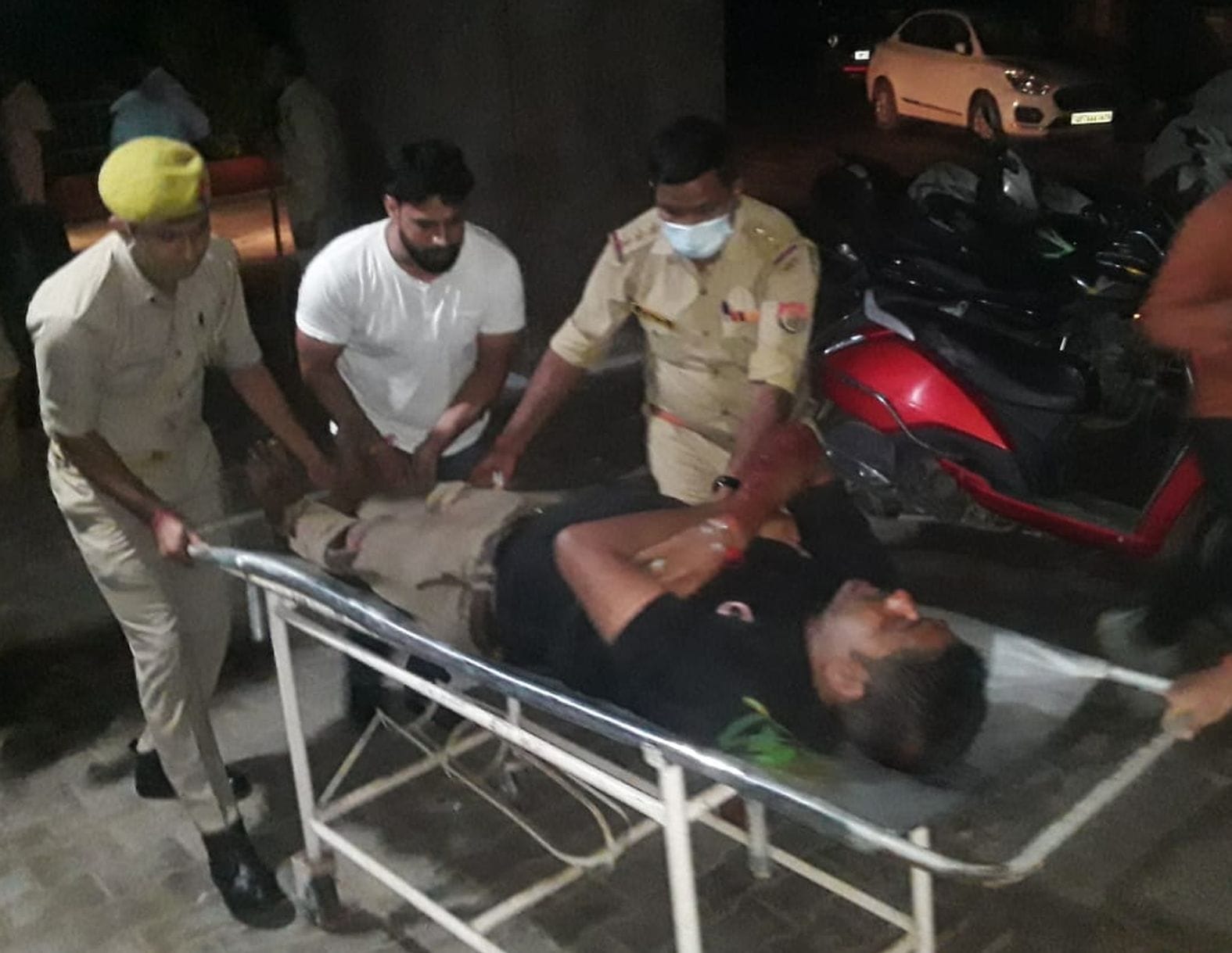 रोडवेज बस में घयाल हुए युवक को स्ट्रेचर से इमरजेंसी में ले जाते पुलिस कर्मी। संवाद