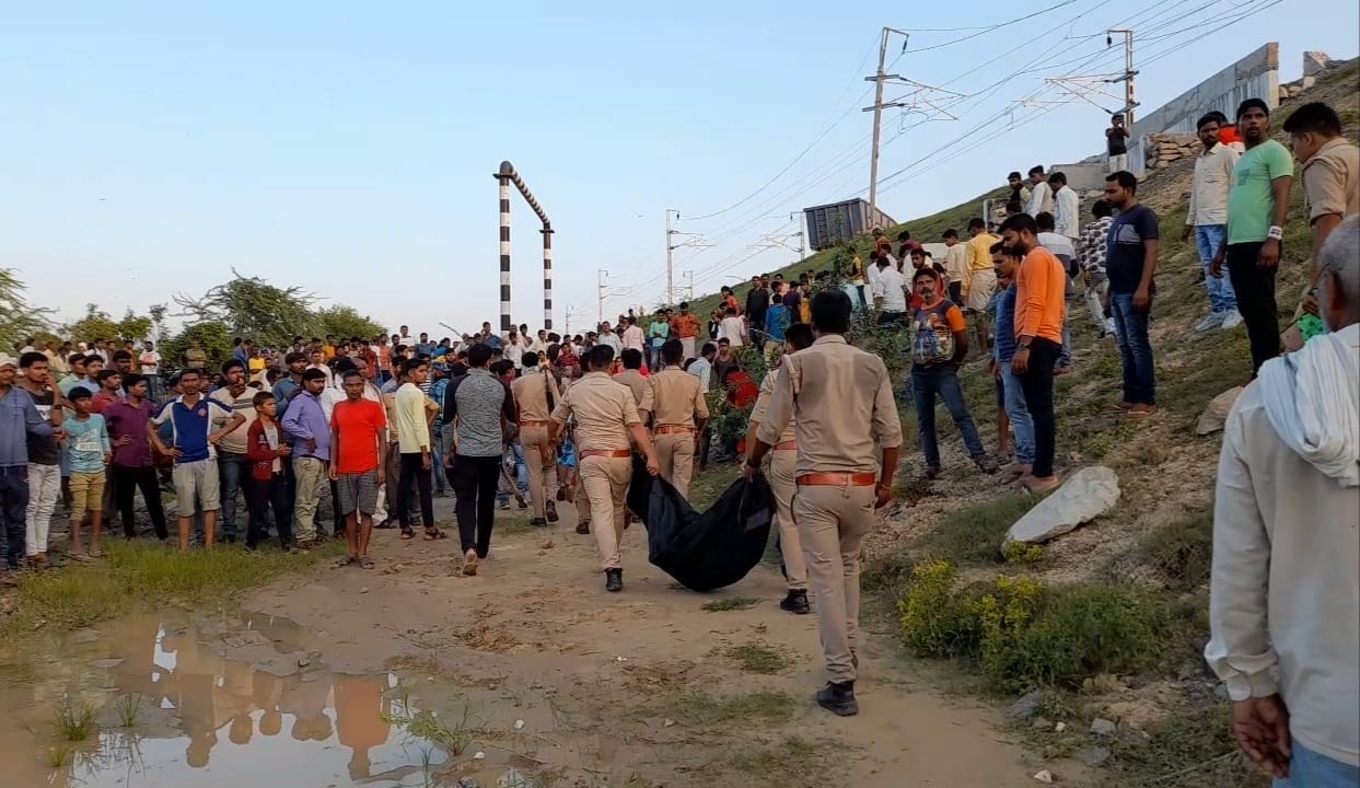 किशोर के शव को ले जाते पुलिस कर्मी