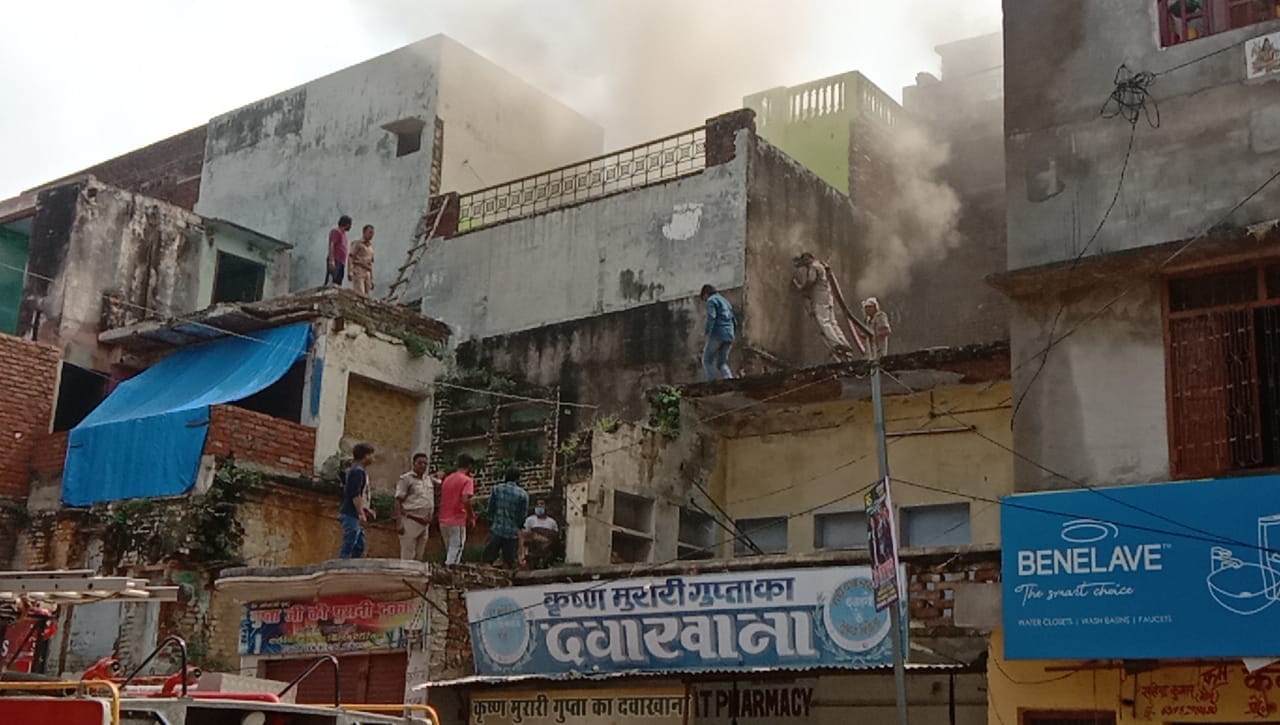 सीढ़ी लगाकर मकान में फंसे लोगों को निकालते पुलिस कर्मी