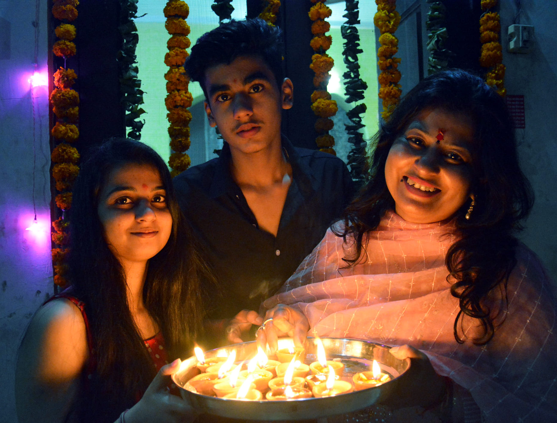मुजफ्फरनगर में दीपावली पर्व थाल में दीयों सजाकर  पूजा करते बच्चें व महिला। ।