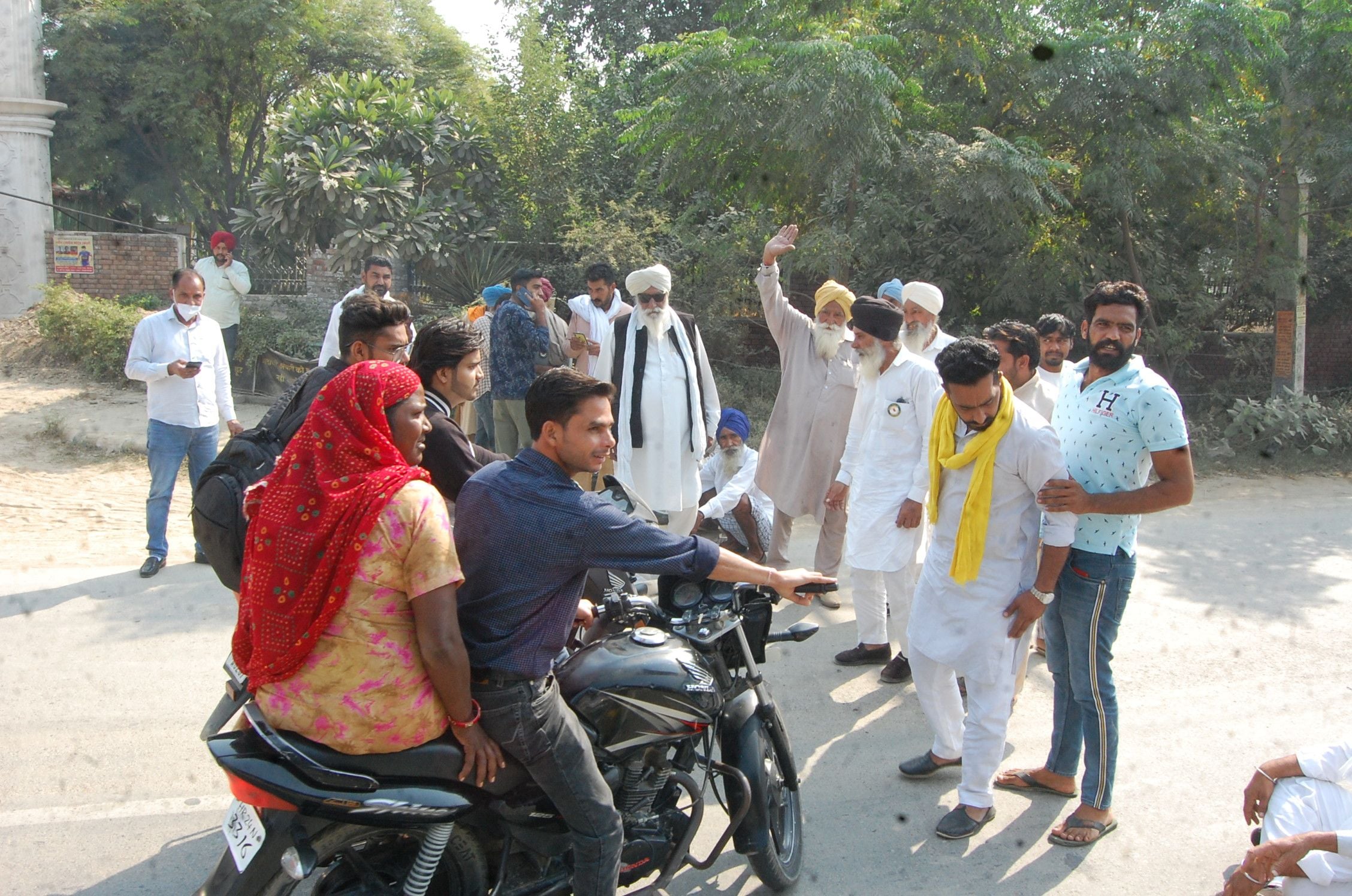 रोड पर खड़े होकर वाहनों को रोकते किसान। 