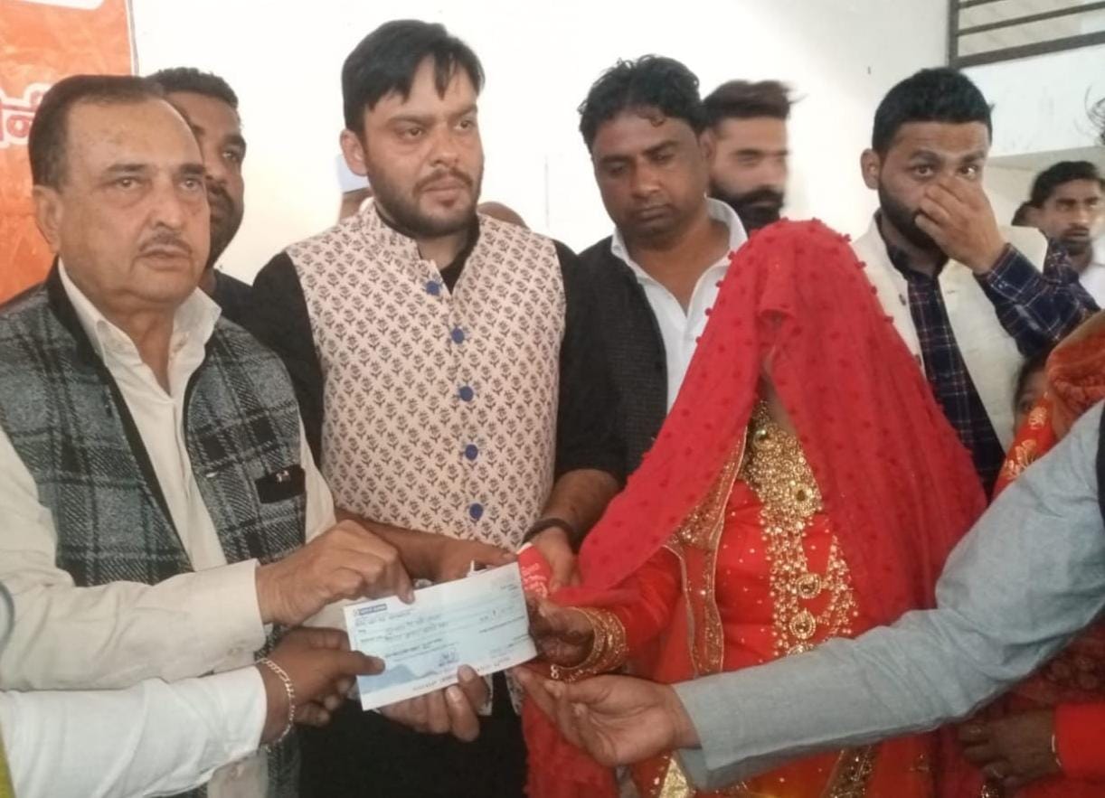 बेहट में नवविवाहित जोड़े को चैक को प्रदान करते सांसद व चेयरमैन