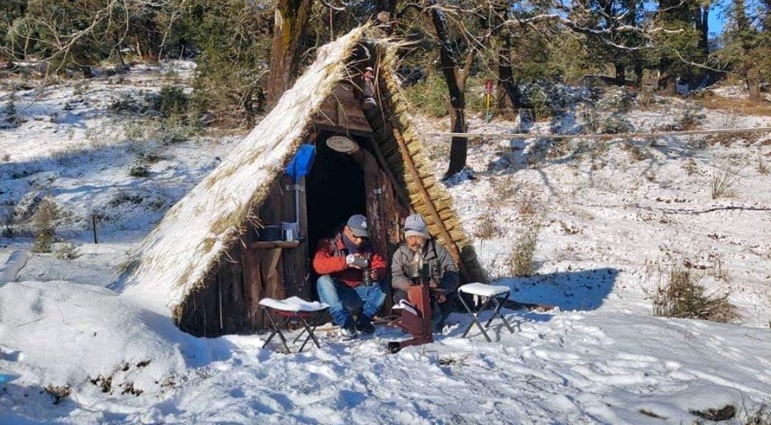 बर्फबारी के बाद ईको पार्क मुनस्यारी में बनी हट में बैठे पर्यटक।