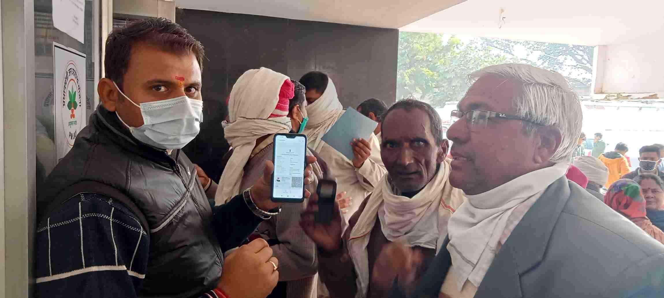 नागरिक अस्पताल के मुख्य गेट पर स्वास्थ्यकर्मी को टीकाकरण प्रमाणपत्र दिखाता बुजुर्ग। संवाद नागरिक अस्पताल के मुख्य गेट पर स्वास्थ्यकर्मी को टीकाकरण प्रमाणपत्र दिखाता बुजुर्ग। संवाद