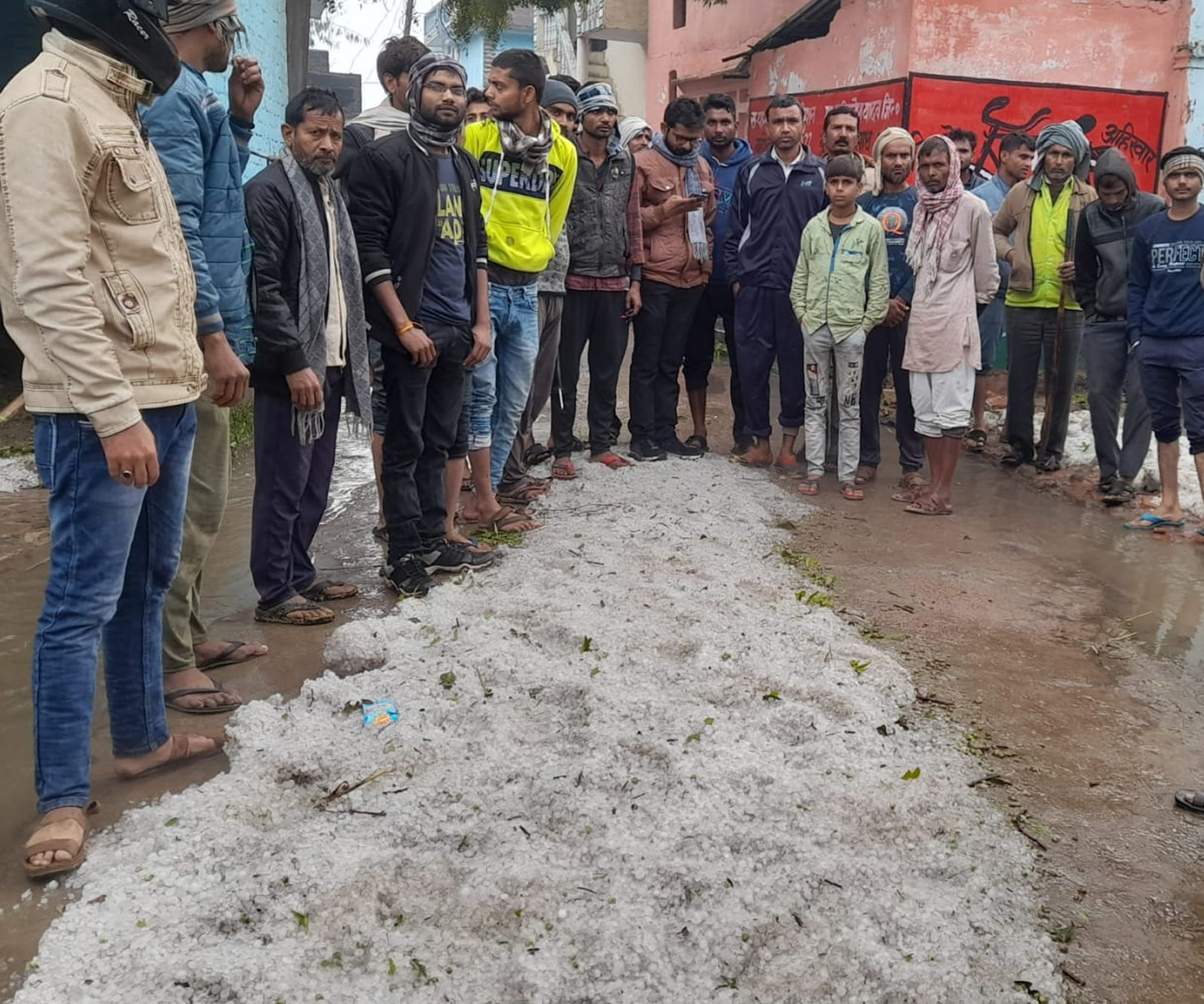 राठ के औंड़ेरा गांव में सड़क पर जमा ओले दिखाते ग्रामीण। राठ के औंड़ेरा गांव में सड़क पर जमा ओले दिखाते ग्रामीण।